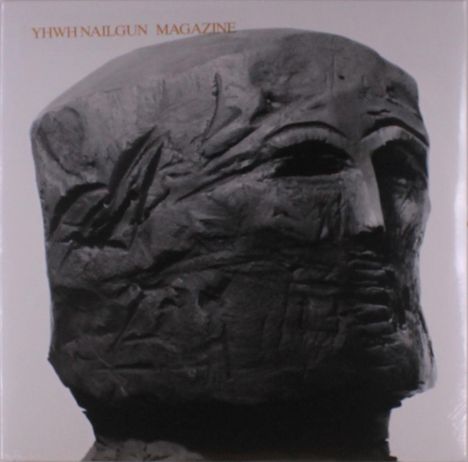„YHWH NAILGUN MAGAZINE“ steht oben. Darunter eine düstere, abstrakte Skulptur eines Gesichts in dunklen Tönen.
