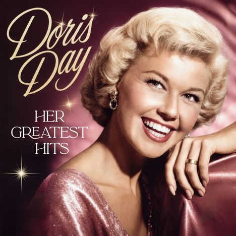 „Doris Day: Her Greatest Hits.“ Eine lächelnde Frau mit blonden Haaren in glitzerndem, rosa Kleid auf rosafarbenem Hintergrund.