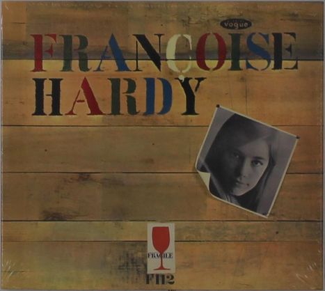 „FRANCOISE HARDY“ in bunten Buchstaben auf Holzoptik, kleines Schwarz-Weiß-Foto des Gesichts einer Frau.