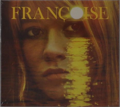 Text: "FRANÇOISE". Eine Frau mit leicht melancholischem Gesichtsausdruck, überlagert mit einem goldenen Lichtreflex.