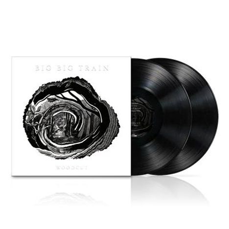 Text: „BIG BIG TRAIN“, darunter „WOODCUT“. Zwei schwarze Schallplatten neben einer Hülle mit einem abstrakten kunstvollen Motiv.