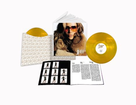 Ein Albumset mit zwei goldenen Schallplatten, einem Bild einer Person mit Sonnenbrille und einem Textheft.