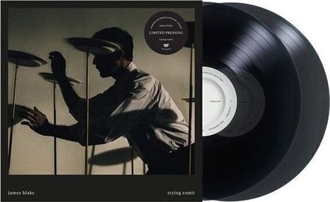 Text: "LIMITED PRESSING," "james blake," "trying to be." Silhouette eines Mannes mit drehenden Tellern; zwei Schallplatten.