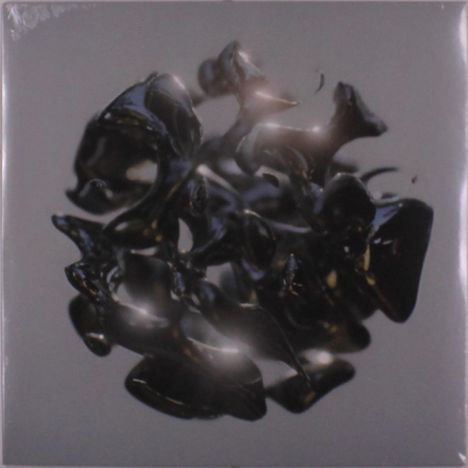 Ein zerklüftetes, glänzendes, schwarzes Objekt schwebt vor grauem Hintergrund.