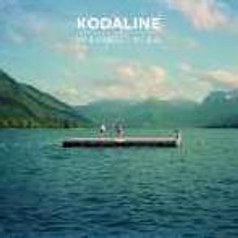 Cover von Kodaline "In a Perfect World". Ein Holzsteg mit Personen darauf schwimmt auf einem großen See, umgeben von Bergen.