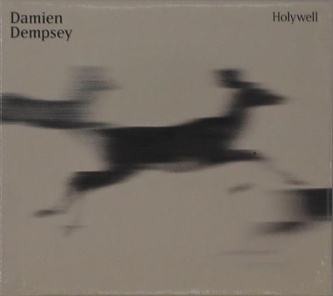Text: "Damien Dempsey" oben links, "Holywell" oben rechts. Verschwommene Konturen eines springenden Hirsches.