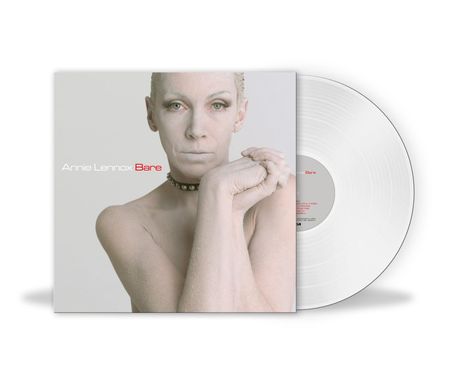 „Annie Lennox Bare“ in weißer Schrift. Eine Frau mit blassem Teint blickt ernst, ihre Hände sind gefaltet. Vinyl sichtbar.