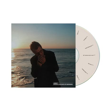 CD-Hülle von "Jamie T - Ghosts (100 Days of Morning)". Ein Mann am Meer bei Sonnenuntergang, die CD daneben.