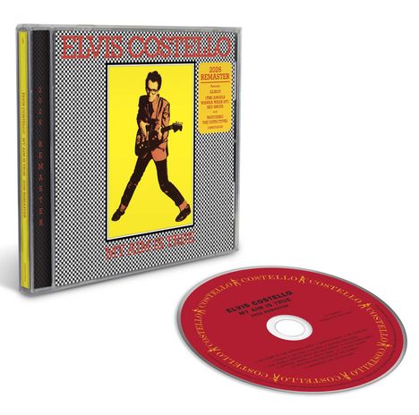 "Elvis Costello, My Aim Is True, 2026 Remaster", CD-Hülle mit Musiker in gelbem Anzug mit Gitarre.