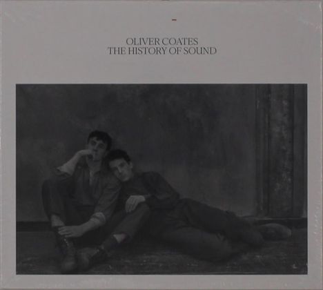 "OLIVER COATES THE HISTORY OF SOUND" steht oben. Zwei Personen sitzen eng beieinander an einer Wand.