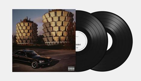 Ein Sammler-Set bestehend aus zwei schwarzen Vinyl-Schallplatten und einem Cover mit zwei großen, gestapelten Gebäuden und einem Auto.
