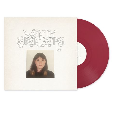 Text: "Wandy Ausenberg". Rotes Vinyl, schwarzes Kleidungsporträt einer Frau auf hellem Hintergrund.