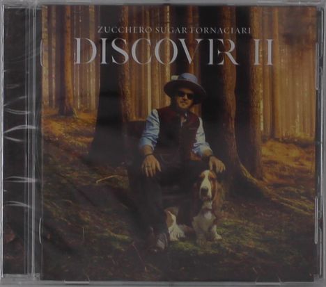 Zucchero Sugar Fornaciari, Discover II. Person mit Hut sitzt im Wald neben einem Hund.