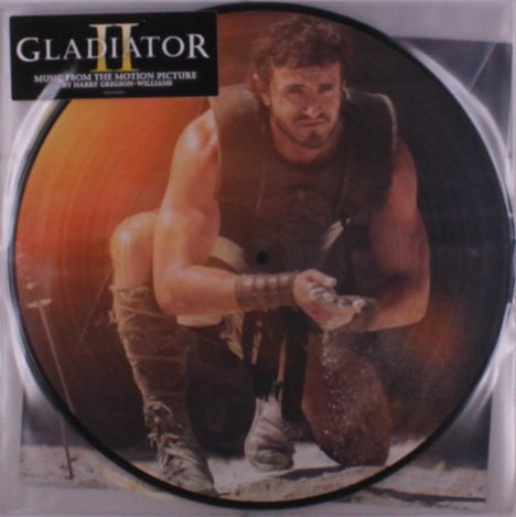 „Gladiator“, „Music from the Motion Picture“, „Harry Gregson-Williams“. Ein Krieger kniet auf sandigem Boden.