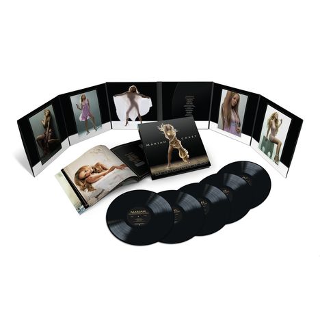 "Mariah Carey". Eine Sammlung aus Schallplatten, einem Booklet und Albumcover in einer stilvoll angeordneten Präsentation.