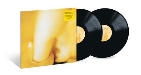 Zwei schwarze Vinyl-Schallplatten mit gelbem Mittellabel, daneben ein gelbes Albumcover mit abstrakter Kunst.