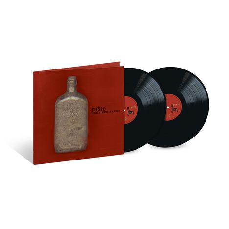 Albumcover „Tonic“ von Medeski Martin & Wood. Rote Hülle mit alter Flasche, zwei schwarze Schallplatten.