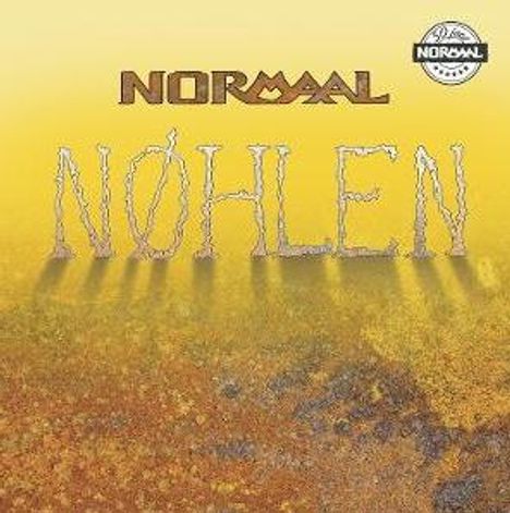 Text: "NORMAAL", "NØHLEN". Illustration von Boden mit gelblichen und bräunlichen Tönen, Logo rechts oben.