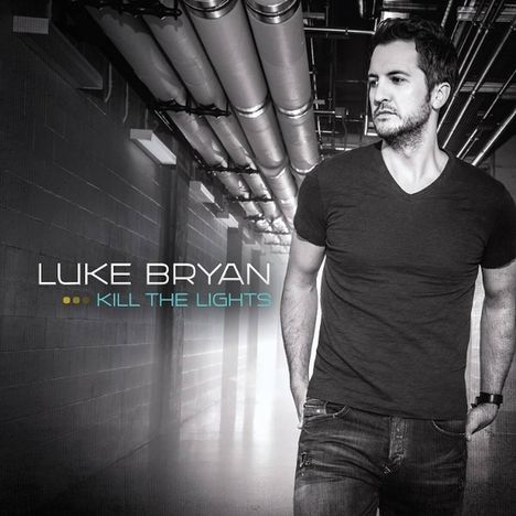 Text: "Luke Bryan, Kill the Lights". Ein Mann in Jeans und T-Shirt steht in einem Industriegang.