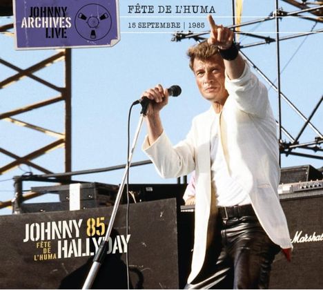 Text: "JOHNNY ARCHIVES LIVE", "FÊTE DE L'HUMA", "15 SEPTEMBRE 1985", "JOHNNY 85 HALLYDAY". Mann in weißer Jacke singt.