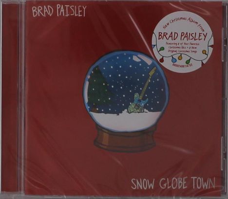 "Brad Paisley" und "Snow Globe Town" auf rotem Cover, mit einer Schneekugel, Gitarre und Tannenbaum.