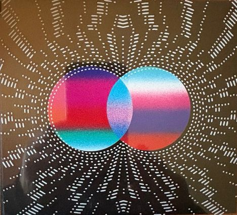 Zwei überlappende, farbige Kreise auf dunklem Hintergrund, strahlenförmig umgeben von weißen Punkten.