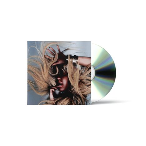 Kein Text ersichtlich. Eine Frau mit langen blonden Haaren liegt zurückgelehnt, die CD-Hülle verdeckt teilweise ihre Gesichtszüge.