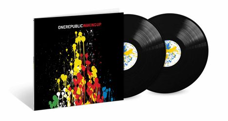 Text: ONEREPUBLIC WAKING UP. Design: Farbkleckse in Gelb, Rot, Blau auf schwarzem Hintergrund. Zwei Schallplatten.
