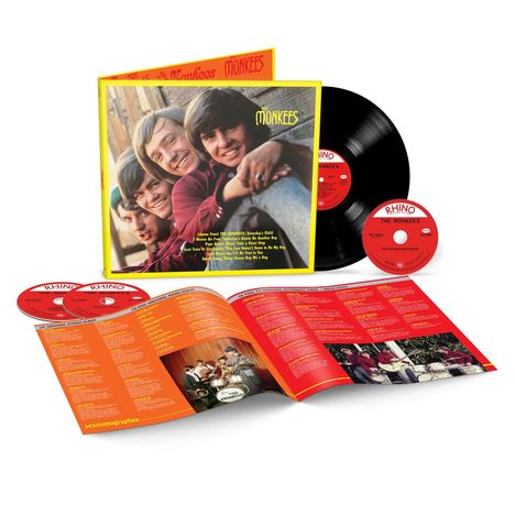 "Rhino", "The Monkees", Albumcover mit lächelnder Band; aufgeklapptes Booklet und Schallplatte daneben.