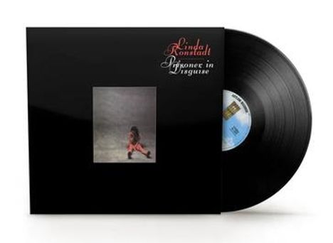 Text: "Linda Ronstadt, Prisoner in Disguise".  
Schwarzes Albumcover mit Foto einer sitzenden Person. Vinyl-Platte rechts.