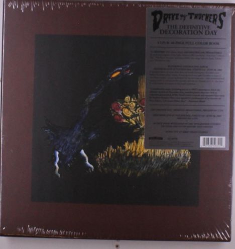 Text: "Drive-By Truckers, The Definitive Decoration Day," schwarze Kreatur mit Blumen in dunkler Landschaft.
