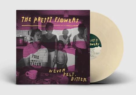 "THE PRETTY FLOWERS" steht oben. "NEVER FELT BITTER" unten. Familienfoto in einem Raum, schlichte Umgebung. Vinyl-Schallplatte dabei.