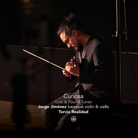 „Curiosa: Lost & Found Tunes“ von Jorge Jiménez. Ein Mann spielt konzentriert Geige in dunkler Umgebung.