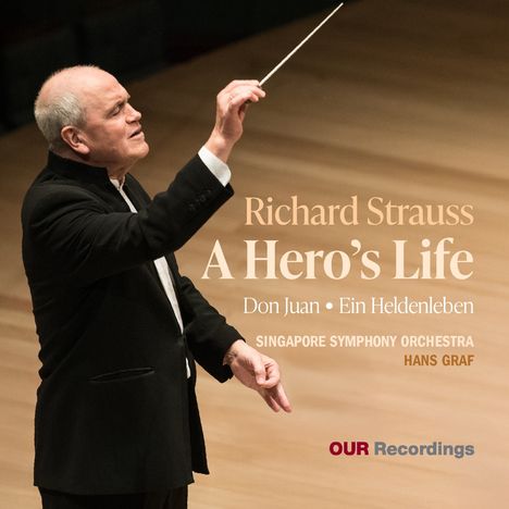 Text: Richard Strauss, A Hero’s Life, Don Juan, Ein Heldenleben, Singapore Symphony Orchestra, Hans Graf, OUR Recordings. 
Ein Dirigent mit Taktstock in schwarzem Anzug.