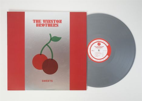 „THE WINSTON BROTHERS“ in Rot auf silbernem Hintergrund, zwei Kirschen darunter. Graue Vinyl-Schallplatte rechts.