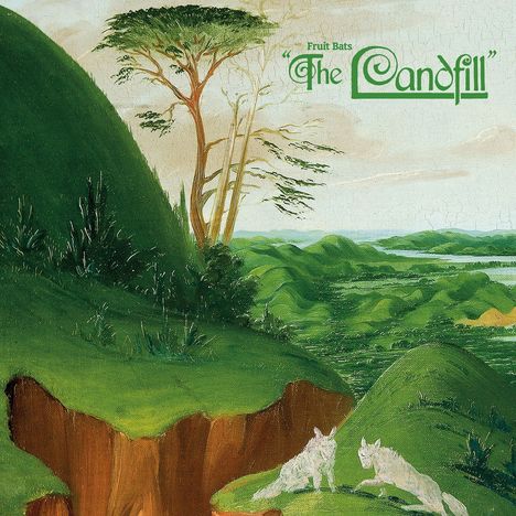 Text: "Fruit Bats The Landfill". Illustration einer grünen Landschaft mit Hügeln, einem Baum und zwei weißen Tieren.