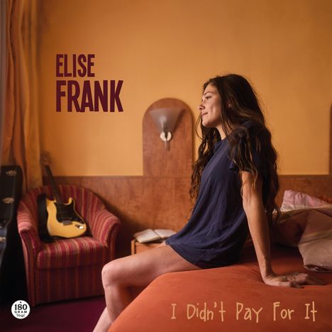 Text: "ELISE FRANK", "I Didn't Pay For It". Frau sitzt auf Bett, Gitarre auf Sessel im Hintergrund.