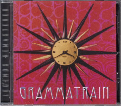 "GRAMMATRAIN" und "LEGENDS REMASTERED" auf rotem Hintergrund mit gelber Uhr und schwarzen Strahlen.