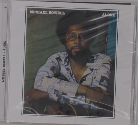 Texte: "MICHAEL HOWELL ALONE". Ein Mann in gemustertem Hemd lehnt auf einer Gitarre. CD-Cover eines Musikalbums.