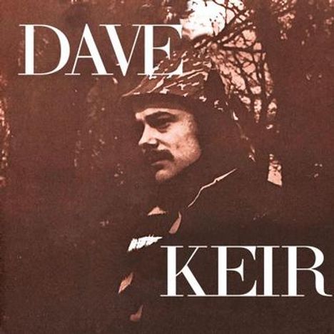 Text: "DAVE KEIR". Ein Mann mit Mütze schaut in die Ferne, umgeben von Bäumen und einer dunklen, stimmungsvollen Atmosphäre.
