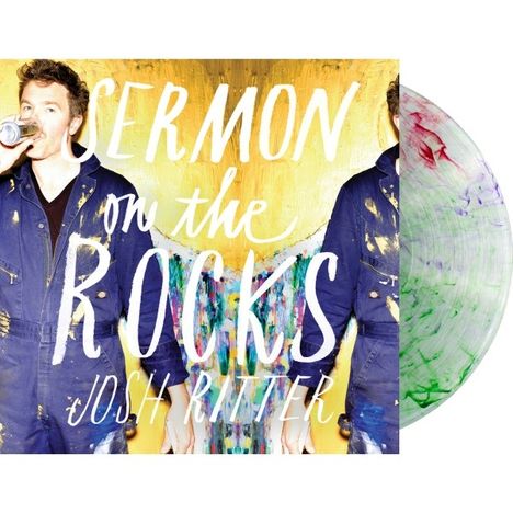 "Sermon on the Rocks, Josh Ritter." Ein Mann in einem Overall mit farbigen Spritzern auf gelbem Hintergrund. Vinyl sichtbar.