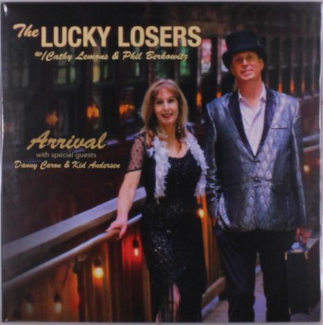 "The Lucky Losers w/ Cathy Lemons & Phil Berkowitz, Arrival, with special guests Danny Caron & Kid Anderson." Zwei Personen elegant gekleidet.