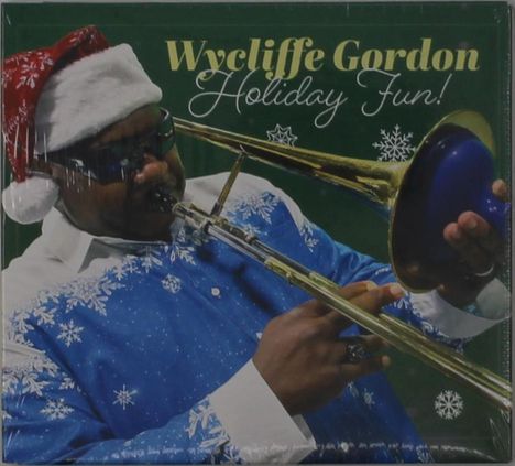 "Wycliffe Gordon Holiday Fun!" Ein Mann mit Sonnenbrille spielt Posaune, trägt blauen Pullover, Weihnachtsmütze.