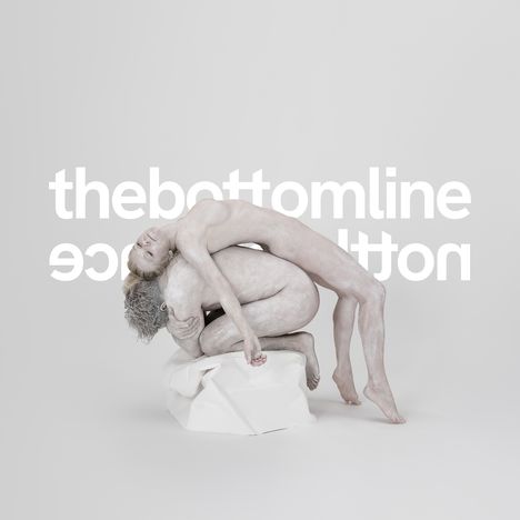 "thebottomline" in weißer Schrift. Zwei hell bemalte Personen in einer künstlerischen Pose auf einem weißen Hintergrund.