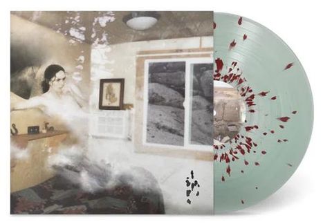 Vinyl-Schallplatte, hellgrün mit roten Sprenkeln. Cover zeigt ein surrealistisches Bild, Frau in einem Raum mit Fenster und Kunstwerk.