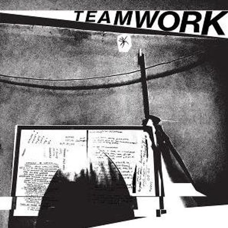 Der Text "TEAMWORK" ist oben. Illustration von Papier und Schatten, ein gespannter Draht verläuft diagonal.