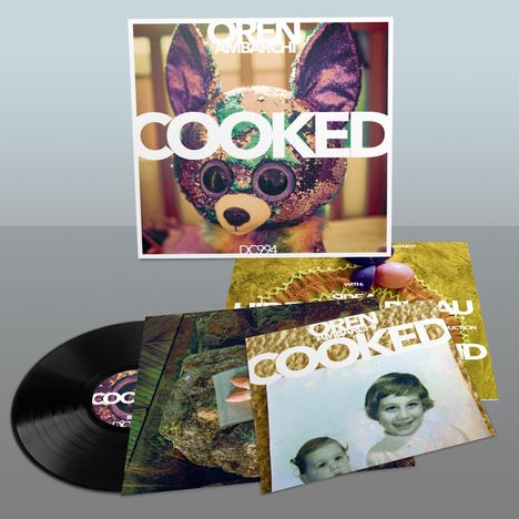 "OREN AMBARCHI COOKED DC994" steht auf einem Albumcover mit einem bunten Tier wie ein Plüschtier im Hintergrund.