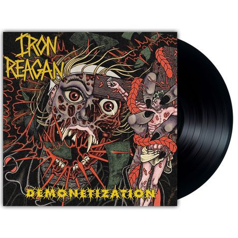 Text: "IRON REAGAN" und "DEMONETIZATION". Illustration: Gruselige, groteske Fratze mit Tentakeln und Monsterelementen.