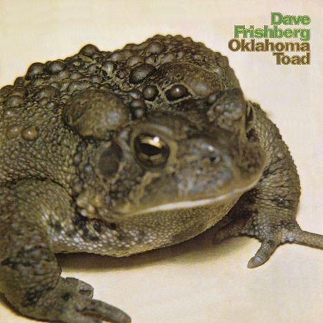 Text: "Dave Frishberg Oklahoma Toad". Großer Frosch mit warziger Haut, Nahaufnahme, beige Hintergrund.