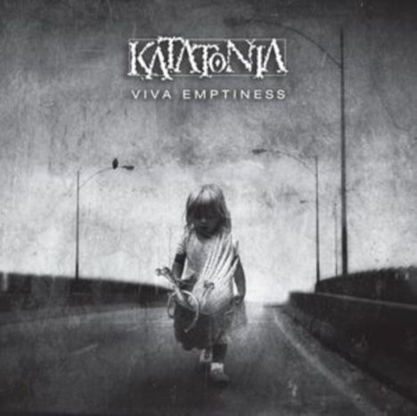 Text: "Katatonia, Viva Emptiness." Ein Kind in der Mitte einer leeren Straße in einem düsteren, grauen Umfeld.